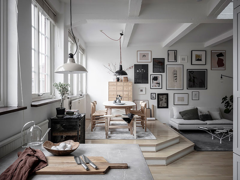 Гостиная с подиумом и кабинет на антресоли: интерьер светлой квартиры в Швеции