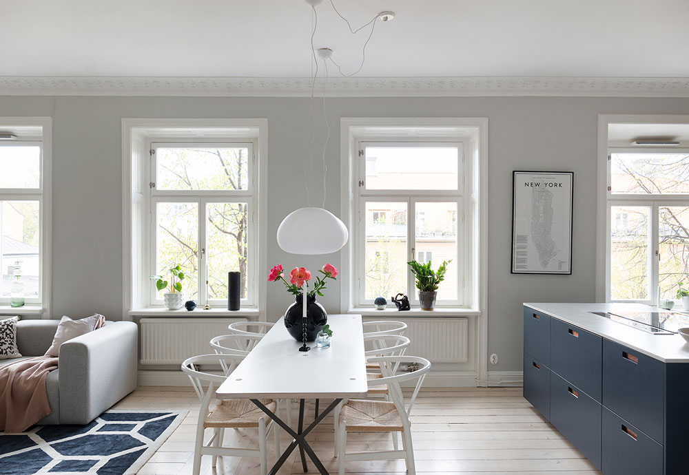 Синяя кухня без верхних шкафчиков и открытая гостиная: приятная квартира в Стокголье (100 кв. м)