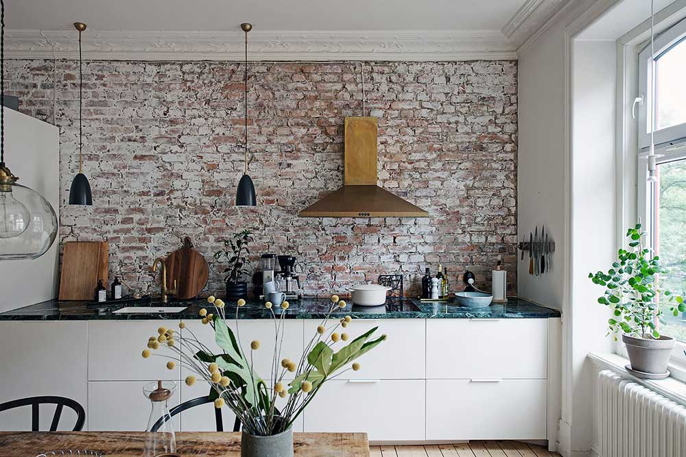 Кирпичная стена на кухне и золотая вытяжка: интересный интерьер в Гётеборге (87 кв.м)